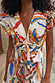 Cotton Banana Kerri Top with a bold banana print, featuring a deep V-neckline, puff sleeves, and a tie-front waist.