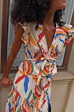 Banana Kerri Top in cotton with a multi-coloured banana print, tie-front and peplum hem. Model is 5ft9 wearing size 10.