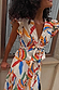 Banana Kerri Top in cotton with a multi-coloured banana print, tie-front and peplum hem. Model is 5ft9 wearing size 10.