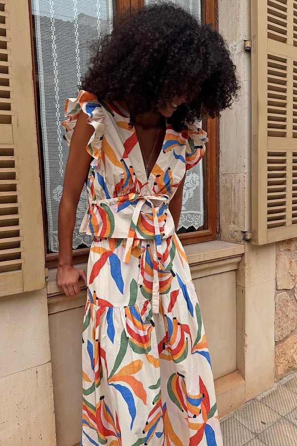 Banana Kerri Top with a multi-coloured banana print and tie-front waist, styled as a co-ord with the matching skirt.