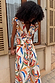 Banana Kerri Top with a multi-coloured banana print and tie-front waist, styled as a co-ord with the matching skirt.