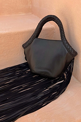 Black Leather Fringe Bag with a plaited handle and fringe detailing, resting on stone steps.