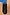 Thumbnail for Black Leather Fringe Bag with a plaited handle and long fringe detail against a terracotta wall.