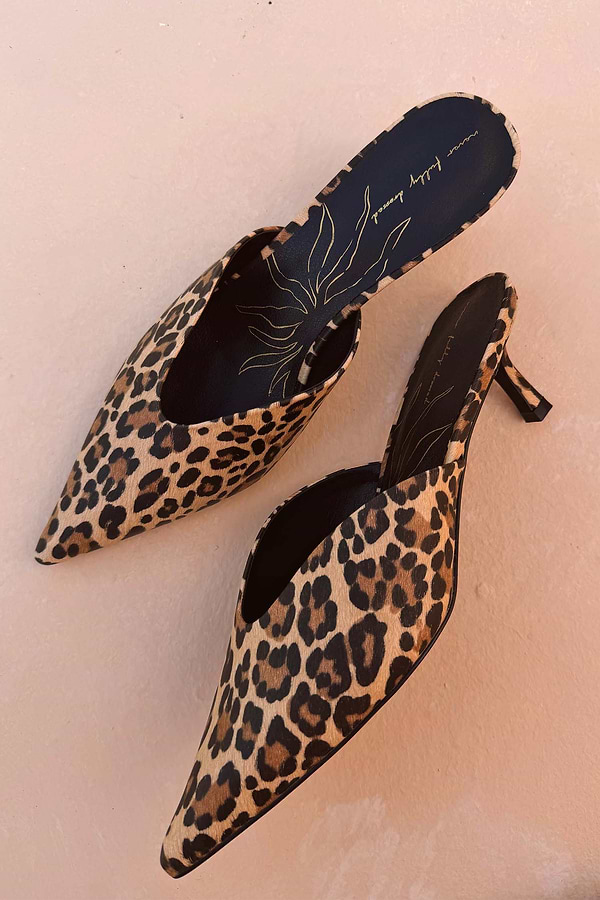 Leopard Heel Mules featuring a pointed toe, kitten heel, and animal print upper with black branded insoles.