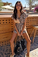 Leopard Print Button-Through Playsuit with a soleil motif and turquoise trim, styled in a vacation setting.