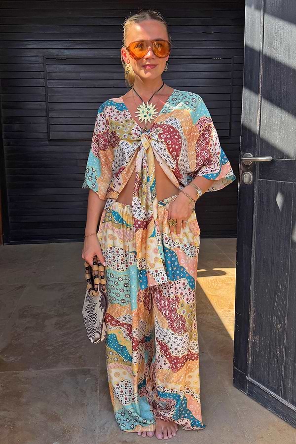 Multi-coloured Morocco Trousers featuring a celestial patchwork print and wide-leg fit, styled as a matching co-ord.