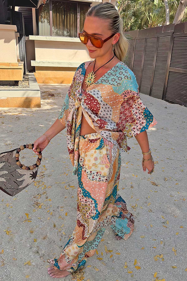 Wide-leg Morocco Trousers in a celestial patchwork print, styled as a summer co-ord with a matching tie-front top.