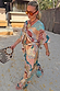 Morocco Tie Front Top and matching trousers in a blue and rust patchwork celestial print for a vacation look.