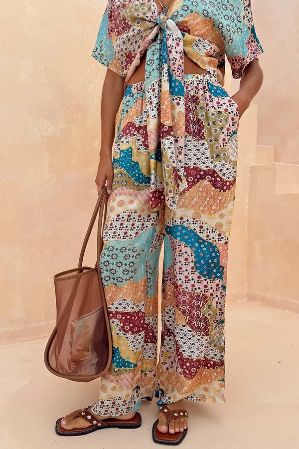Wide-leg Morocco Trousers in a celestial patchwork print, styled as a summer co-ord with a matching tie-front top.
