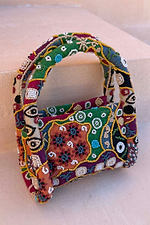 Morocco Beaded Bag featuring hand-beaded abstract designs in multi-coloured autumnal tones.