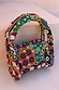 Morocco Beaded Bag featuring hand-beaded abstract designs in multi-coloured autumnal tones.