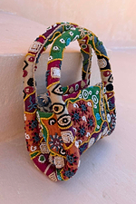 Morocco Beaded Bag featuring hand beaded abstract patterns in green, orange and silver with top handles.