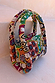 Morocco Beaded Bag featuring hand beaded abstract patterns in green, orange and silver with top handles.