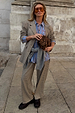 Grey check trousers and matching blazer co-ord styled with a blue striped shirt and leopard print clutch bag.