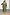 Thumbnail for Khaki Celia Plisse Dress with long sheer sleeves and v neck, styled with a blue clutch and leopard print heels.