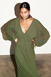 Multi-wear Khaki Celia Plisse Dress with long sheer sleeves and a plunging v-neck on a model