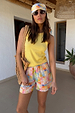 Lemon Ribbed Tank in yellow soft stretch fabric, styled with floral shorts and a headscarf for a vacation look.