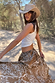 White Cowgirl Tank in ribbed fabric, styled with a brown bandana print skirt and cowgirl hat for a 90s feel.