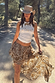 Thumbnail for White Cowgirl Tank in ribbed fabric with a gold horse print, styled with a brown paisley skirt and cowboy hat.
