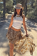 White Cowgirl Tank in ribbed fabric with a gold horse print, styled with a brown paisley skirt and cowboy hat.