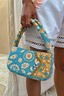 Blue and Yellow Morocco Beaded bag featuring hand-embellished glass beads and iconic gold NFD motifs.