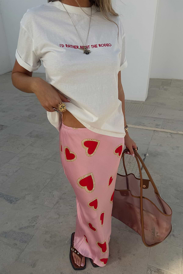 Pink Hearts Dorris midaxi skirt with red heart print and signature key motifs, styled with a white graphic t-shirt.