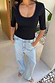 Thumbnail for Black Teddy T-Shirt with a mesh scoop neckline and elbow-length sleeves, styled with light wash jeans.