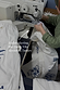 Dolce Vita cream denim jeans being embroidered with blue Greek-inspired motifs at a sewing machine in Turkey.