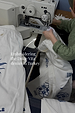Dolce Vita cream denim jeans being embroidered with blue Greek-inspired motifs at a sewing machine in Turkey.