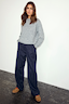 Navy Pinstripe Arden Trousers Petite styled with a grey knit sweater and leopard print trainers.