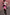 Thumbnail for Iconic Pink Vegan Leather Mini Jaspre Skirt styled with a patterned cardigan and brown knee-high boots.