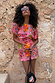 Pink Fruit Stamps Mini Dress in a vibrant cotton-stretch T-shirt style with a playful fruit print on a model.