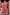 Thumbnail for Pink Fruit Stamps Mini Dress with a fruit motif and t-shirt silhouette, styled against a textured stone wall.