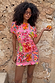 Pink Fruit Stamps Mini Dress in a t-shirt silhouette with a fruit print, designed in London for a vacation look.
