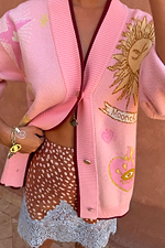 Pink Mystical Cardigan with sun and moon jacquard motifs, burgundy trims and a transeasonal soft knit finish.