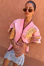 Pink Mystical Cardigan in a soft knit with a sun jacquard motif and burgundy trims, paired with a patterned lace skirt.