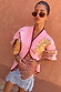 Pink Mystical Cardigan in a soft knit with a sun jacquard motif and burgundy trims, paired with a patterned lace skirt.