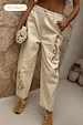 Ecru Raffia Palma Barrel Leg Jeans featuring brown floral raffia embroidery on a cream denim base.