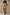 Thumbnail for Rio A-Symmetric Skirt in tropical fruit print, styled as a co-ord set against a textured stone wall.