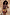 Thumbnail for Rio Mini Maeva Skirt featuring a tropical fruit print and brown lace trim, worn by a model against a stone wall.