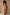 Thumbnail for Rio A-Symmetric Skirt in a tropical fruit print with an angled hem, styled as a co-ord against a textured wall.