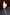 Thumbnail for Iconic Leopard Mini Jaspre wrap skirt styled with a white blouse against a dark wood wall.