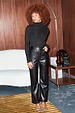 Model wears straight leg Black Vegan Leather Trousers with a sparkly turtleneck and leopard heels.