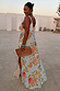 Sky Blue Floral Sofia Dress with a side slit and tie shoulders, shown on a model for inclusive sizing.