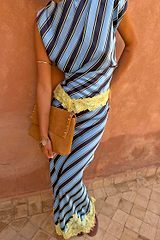 Stripe A-Symmetrical Top with blue diagonal lines and yellow lace trim, paired with a matching skirt and tan clutch.