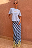 Stripe Maeva Skirt with blue diagonal stripes and a yellow lace hem, styled with a light blue tee.