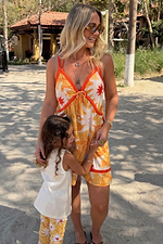 Yellow Sun Mini Dress in cotton with a sun print, contrast trims and tie front on a sunny beach vacation.