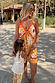 Yellow Sun Mini Dress in cotton with a sun print, contrast trims and tie front on a sunny beach vacation.