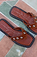 Tan leather stud sandals with silver hardware, a square toe and flat sole, featuring a sun graphic on the footbed.