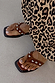 Tan Leather Stud Sandals with silver studs and a square toe, styled with a leopard print skirt.